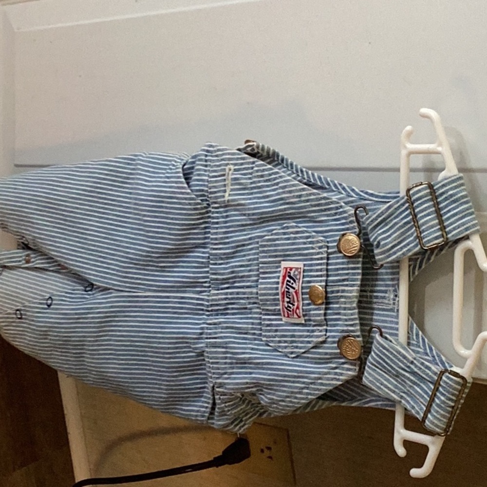 Boy’s striped blue and white overalls.